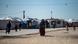 Women with children walk at Camp Roj, where relatives of people suspected of belonging to the Islamic State (IS) group are held Women with children walk at Camp Roj, where relatives of people suspected of belonging to the Islamic State (IS) group are held