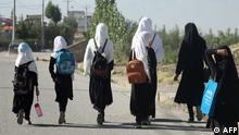 TOPSHOT - Girls walk to their school along a road in Gardez, Paktia porvince, on September 8, 2022. - Five government secondary schools for girls have resumed classes in eastern Afghanistan after hundreds of students demanded they reopen, provincial officials said on September 8. Officially the Taliban have banned girls secondary school education, but the order has been ignored in a few parts of Afghanistan away from the central powerbases of Kabul and Kandahar (Photo by AFP)