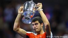 NEW YORK, NEW YORK - SEPTEMBER 11: Carlos Alcaraz of Spain celebrates with the championship trophy after defeating Casper Ruud of Norway during their Men’s Singles Final match on Day Fourteen of the 2022 US Open at USTA Billie Jean King National Tennis Center on September 11, 2022 in the Flushing neighborhood of the Queens borough of New York City. (Photo by Elsa/Getty Images)