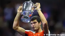 NEW YORK, NEW YORK - SEPTEMBER 11: Carlos Alcaraz of Spain celebrates with the championship trophy after defeating Casper Ruud of Norway during their Men’s Singles Final match on Day Fourteen of the 2022 US Open at USTA Billie Jean King National Tennis Center on September 11, 2022 in the Flushing neighborhood of the Queens borough of New York City. (Photo by Elsa/Getty Images)