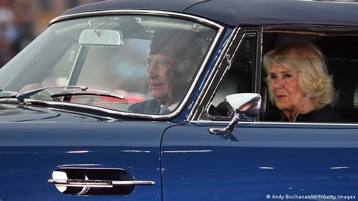 King Charles and wife Camilla in the Aston Martin