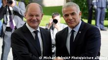 German Chancellor Olaf Scholz, left, welcomes Israeli Prime Minister Yair Lapid, right, for a meeting at the chancellery in Berlin, Germany, Monday, Sept. 12, 2022. (AP Photo/Michael Sohn)