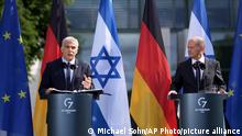 German Chancellor Olaf Scholz, right, and Israeli Prime Minister Yair Lapid, left, address the media during a joint press conference as part of a meeting at the chancellery in Berlin, Germany, Monday, Sept. 12, 2022. (AP Photo/Michael Sohn)