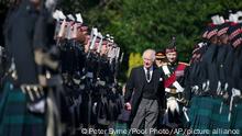 King Charles III inspects the Guard of Honour as he arrives to attend the Ceremony of the Keys, at the Palace of Holyroodhouse, Edinburgh, Monday, Sept. 12, 2022. Queen Elizabeth II, Britain's longest-reigning monarch and a rock of stability across much of a turbulent century, died Thursday Sept. 8, 2022, after 70 years on the throne. She was 96. (Peter Byrne/Pool Photo via AP)