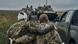 A Ukrainian soldier helps a wounded fellow soldier on the road in the freed territory in the Kharkiv region A Ukrainian soldier helps a wounded fellow soldier on the road in the freed territory in the Kharkiv region