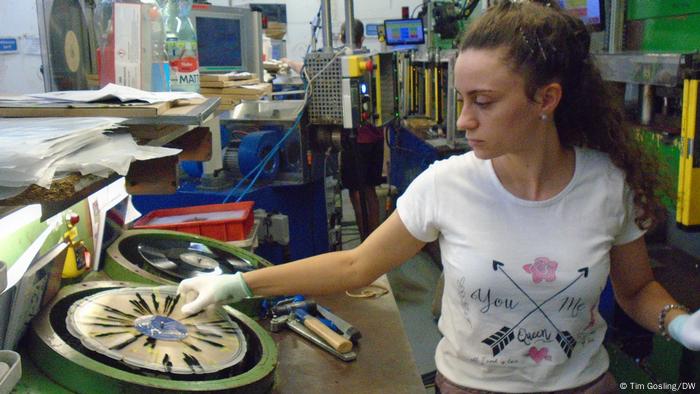 A female worker handling a vinyl record press at the GZ Media plant in Lodenice, Czechia