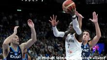 Germany's Dennis Schroeder, center, is challenged by Kostas Papanikolaou, left, and Giannoulis Larentzakis, right, of Greece during the Eurobasket quarterfinal basketball match between Germany and Greece in Berlin, Germany, Tuesday, Sept. 13, 2022. (AP Photo/Michael Sohn)