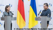 A handout photograph taken on September 10, 2022 and released by Ukrainian Foreign Ministry Press Service, shows Ukrainian Foreign Minister Dmytro Kuleba (R) and his German counterpart Annalena Baerbock (L) attend a joint press conference in Kyiv, amid the Russian military invasion of Ukraine. - German Foreign Minister Annalena Baerbock arrived in Kyiv on September 10, 2022, on a surprise visit, which she said was to demonstrate Berlin's unwavering support for Ukraine in its battle against Russia. It is her second trip to Ukraine and comes a week after Ukrainian Prime Minister Denys Shmygal's trip to Berlin where he had repeated Kyiv's call for weapons. (Photo by HANDOUT / Ukrainian Foreign Ministry press-service / AFP) / RESTRICTED TO EDITORIAL USE - MANDATORY CREDIT AFP PHOTO / UKRAINIAN FOREIGN MINISTRY PRESS-SERVICE - NO MARKETING NO ADVERTISING CAMPAIGNS - DISTRIBUTED AS A SERVICE TO CLIENTS