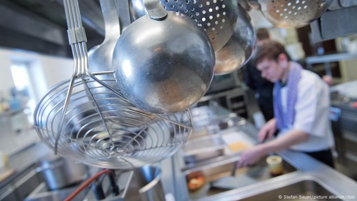 A person in a kitchen prepares food.