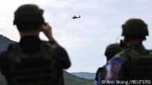 Members of the media take photos of an AH-64 Apache during a live-fire military exercise in Pingtung, Taiwan, September 7, 2022. REUTERS/Ann Wang