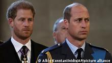 Britain's William, Prince of Wales, and Prince Harry react as the coffin of Britain's Queen Elizabeth arrives at Westminster Hall from Buckingham Palace for her lying in state, in London, Britain, Wednesday, Sept. 14, 2022. (Alkis Konstantinidis/Pool photo via AP)