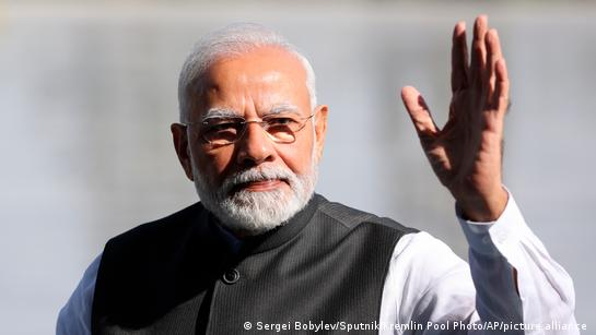 Indian Prime Minister Narendra Modi waves his hand 