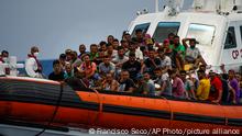 Migrants mostly from Tunisia rest on board an Italian coast guard ship after being rescued southwest of the Italian island of Lampedusa in the Mediterranean sea, Saturday, Aug. 6, 2022. (AP Photo/Francisco Seco)