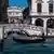 Tourists take a gondola ride in Venice