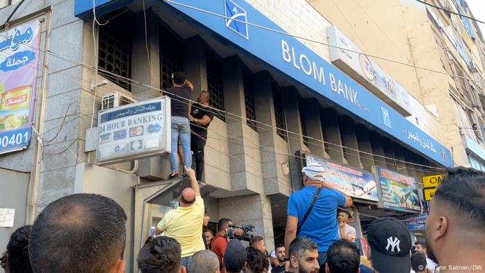 Lebanese citizens gathered outside a Beirut branch of Blom Bank to support of a depositor who is taking hostages and demanding to withdraw his deposit.