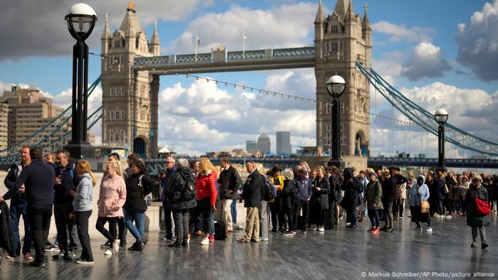 People waiting in line in front of London's tower bridge People waiting in line in front of London's tower bridge
