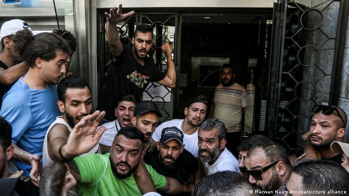 لبنانيون تجمعوا أمام أحد البنوك، تعرض لهجوم من قبل شخص، طالب بالحصول على ودائعه بالبنك. 