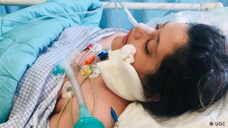 A photo of Iranian Mahsa Amini in hospital, in a bed, hooked up to medical equipment