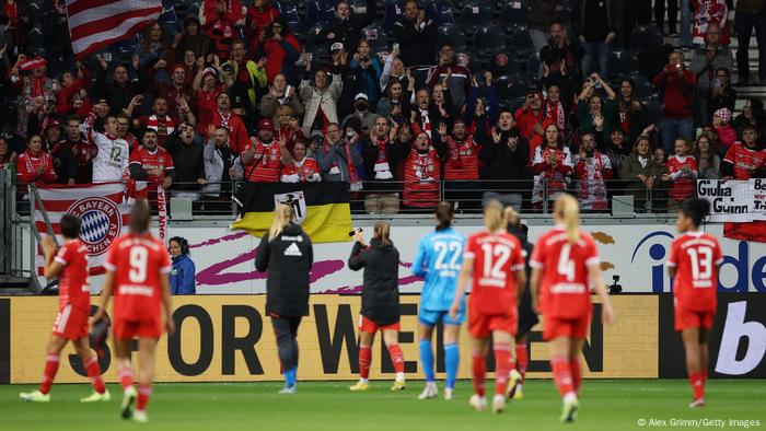 The Bayern Munich players celebrate with their fans after the draw in Frankfurt.