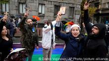 Anti-gay protesters hold icons and crosses as they stand on a large rainbow flag during the European LGBTQ pride march in Belgrade, Serbia, Saturday, Sept. 17, 2022. Serbian police have banned Saturday's parade, citing a risk of clashes with far-right activists. (AP Photo/Darko Vojinovic)