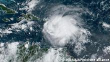 This satellite image provided by NOAA shows Tropical Storm Fiona in the Caribbean on Saturday, Sept. 17, 2022. Fiona threatened to dump up to 16 inches (41 centimeters) of rain in parts of Puerto Rico on Saturday as forecasters placed the U.S. territory under a hurricane watch and people braced for potential landslides, severe flooding and power outages. (NOAA via AP)