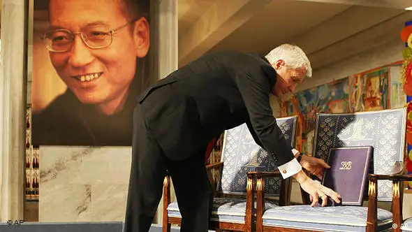 Chairman of the Norwegian Nobel Committee Thorbjoern Jagland places the Nobel diploma and Nobel medal on the empty chair during the ceremony in Oslo City Hall Friday Dec. 10, 2010 to honour in absentia this years Nobel Peace Prize winner, jailed Chinese dissident Liu Xiaobo. (AP Photo Heiko Junge, pool)