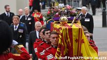 The coffin of Queen Elizabeth II, draped in the Royal Standard with the Imperial State Crown and the Sovereign's orb and sceptre, is carried in to Westminster Abbey, London on September 19, 2022. (Photo by Geoff PUGH / POOL / AFP) (Photo by GEOFF PUGH/POOL/AFP via Getty Images)