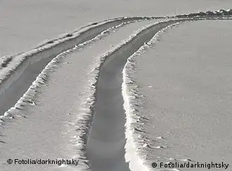 Tracks through the snow lead off to the horizon