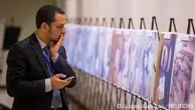 10.5.2015, New York, USA, FILE PHOTO: ATTENTION EDITORS - VISUALS COVERAGE OF SCENES OF DEATH
A man reacts as he looks at a gruesome collection of images of dead bodies taken by a photographer, who has been identified by the code name Caesar, at the United Nations Headquarters in New York, March 10, 2015. The pictures were smuggled out of Syria between 2011 and mid-2013. The exhibition at the UN consists of two dozen images selected from the roughly 55,000 photographs taken in Syria by a former military police photographer - some showing eye gougings, strangulation and long-term starvation - as the conflict in Syria enters its fifth year. REUTERS/Lucas Jackson/File Photo