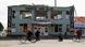 People walks and bike past a severely damaged building in Balakliya People walks and bike past a severely damaged building in Balakliya
