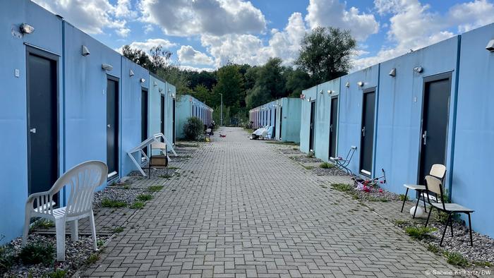 An outside view of a row of blue containers, no people