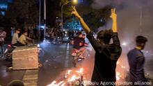TEHRAN, IRAN - SEPTEMBER 19: People gather during a protest for Mahsa Amini, who died after being arrested by morality police allegedly not complying with strict dress code in Tehran, Iran on September 19, 2022. Stringer / Anadolu Agency