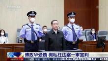 In this image taken from video footage run by China's CCTV, former Chinese justice minister Fu Zhenghua is escorted by court police as he attends a court session for his verdict announcement in Changchun, northeastern China's Jilin province on Thursday, Sept. 22, 2022. The former Chinese justice minister was sentenced to death with a two-year reprieve on charges of taking bribes and helping criminals including his brother hide illegal activity, state TV reported Thursday. (CCTV via AP)