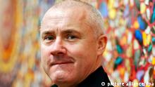 FILE - epa03986006 The file picture dated 02 April 2012 shows British artist Damien Hirst posing in front of his painting 'I Am Become Death, Shatterer of Worlds' at the retrospective exhibition held at the Tate Modern museum in London, Britain. EPA/KERIM OKTEN EDITORIAL USE ONLY (zu dpa-Korr «Damien Hirst wird 50: Haie, Kühe und das ganz große Geld» Wiederholung am 05.06.2015) +++ dpa-Bildfunk +++