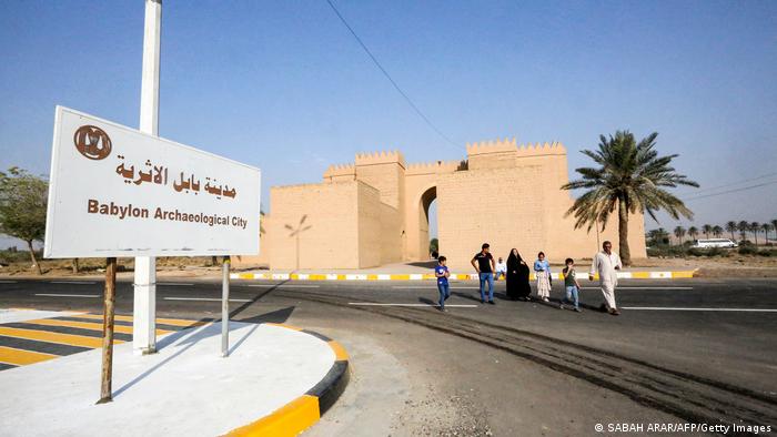 Visitors walk away from the archaeological site of ancient Babylon in Iraq.