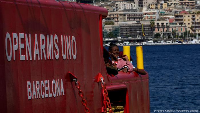 Una migrante sonríe a bordo de un barco salvavidas de la ONG española Open Arms, al arribar al puerto italiano de Messina, el 22 de septiembre de 2022.