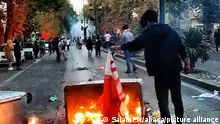 Iranian flag beingÂ set on fireÂ in Hamadan city durning protest for Mahsa Amini, a woman who died after being arrested by the Islamic republic's morality police, in Tehran on September 19, 2022. Fresh protests broke out on September 19 in Iran over the death of a young woman who had been arrested by the morality police that enforces a strict dress code, local media reported. Public anger has grown since authorities on Friday announced the death of Mahsa Amini, 22, in a hospital after three days in a coma, following her arrest by Tehran's morality police during a visit to the capital on September 13. Tehran, Iran on September 21, 2022. Photo by SalamPix/ABACAPRESS.COM