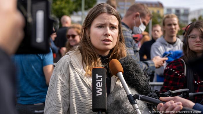 Climate protection activist Luisa Neubauer speaks into microphones