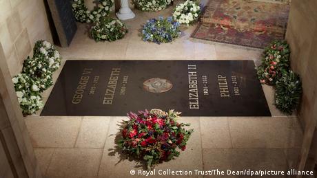 Marble memorial slab for Queen Elizabeth II surrounded by flowers