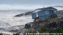 In this photo provided by Wreckhouse Press a home fights against high winds caused by post Tropical Storm Fiona in Port aux Basques, Newfoundland and Labrador, Saturday, Sept. 24, 2022. The home has since been lost at sea. (Rene Roy/Wreckhouse Press via AP)