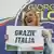 Giorgia Meloni shows a placard reading in Italian 'Thank you Italy' at her party's electoral headquarters in Rome