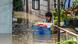 A resident carries belongings while evacuating from his submerged home in the aftermath of Super Typhoon Noru. A resident carries belongings while evacuating from his submerged home in the aftermath of Super Typhoon Noru.