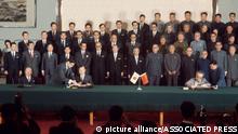FILE - Japanese Prime Minister Kakuei Tanaka, sitting at center left, with Foreign Minister Masayoshi Ohira, far left, and Chinese Premier Zhou Enlai, center right, sign the joint statement to normalize relations between the countries in Beijing on Sept. 29, 1972. Thursday, Sept. 29, 2022, marks the 50th anniversary of the historic communique that Tanaka signed with Zhou. (AP Photo, File)