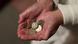 Photo of an elderly woman holding pound coins in her hands Photo of an elderly woman holding pound coins in her hands