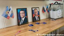25.09.2022 *** Portraits of Leonid Pasechnik, leader of self-proclaimed Luhansk People's Republic, left, and Russian President Vladimir Putin are displayed next to a mobile ballot box at a polling station in a maternity hospital during a referendum in Luhansk, Luhansk People's Republic, controlled by Russia-backed separatists, eastern Ukraine Ukraine, Sunday, Sept. 25, 2022. Voting began Friday in four Moscow-held regions of Ukraine on referendums to become part of Russia. (AP Photo)