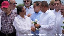 Colombia's President Gustavo Petro, left, and Venezuela's Transportation Minister Ramon Araguayan shake hands on the Simon Bolivar International Bridge during a ceremony to mark its reopening, between Cucuta, Colombia and San Antonio del Tachira, Venezuela, Monday, Sept. 26, 2022. Vehicles with merchandise will cross the bridge on Monday in a ceremonial act to seal the resumption of commercial relations between the two nations. (AP Photo/Fernando Vergara)
