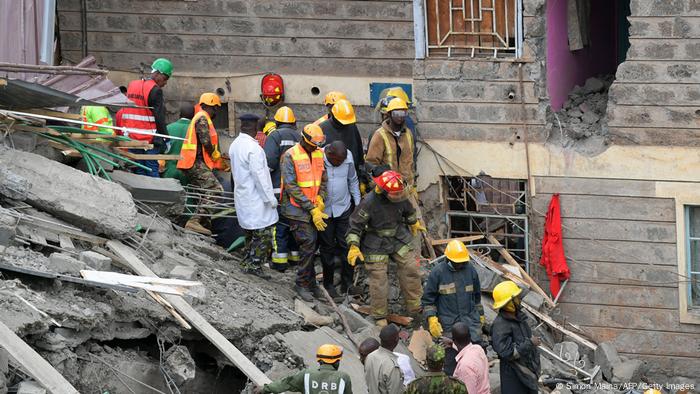 Rescuers help people from a collapsed building in Kirigiti, Kiambu county in Kenya