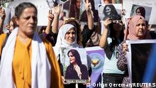 Women carry pictures during a protest over the death of 22-year-old Kurdish woman Mahsa Amini in Iran, in the Kurdish-controlled city of Qamishli, northeastern Syria September 26, 2022. REUTERS/Orhan Qereman NO RESALES. NO ARCHIVES.
