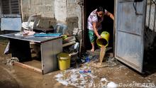 A woman clears her home from mud following the flood caused by Super Typhoon Noru, in Marikina City, Metro Manila, Philippines, September 26, 2022. REUTERS/Lisa Marie David