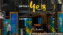 A customer waits for service at a Optus phone store in Sydney, Australia, Thursday, Oct. 7, 2021. (AP Photo/Mark Baker)